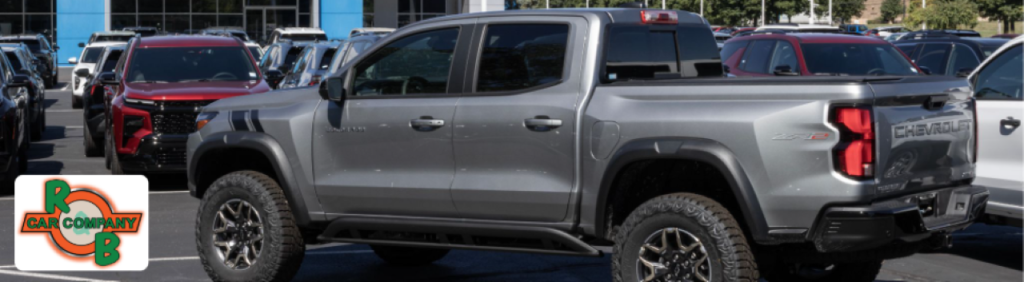 A customer with a sales representative reviewing a Chevrolet Truck purchase at R&B Car Company in Warsaw, Indiana.
