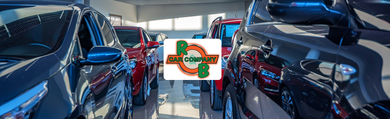 A row of new cars parked in a showroom with different colors and makes