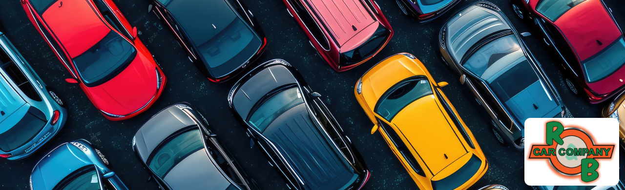 An aerial view of a large parking lot filled with various cars in different colors. 