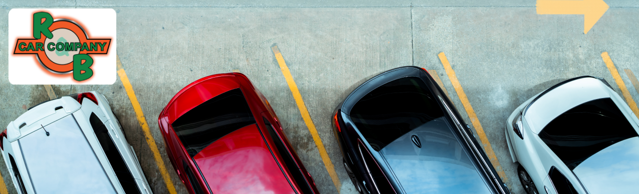 Cars parked in a lot with an RB car company logo in the corner.